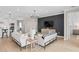 Bright and spacious living room, adjacent to the kitchen, with black accent wall and modern decor at 6035 Blue View Way, St Cloud, FL 34771