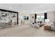 Spacious living room featuring high ceilings, modern lighting, neutral carpet and versatile layout at 6035 Blue View Way, St Cloud, FL 34771