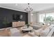 Comfortable living room featuring a modern design, stylish furniture, and access to the outdoors at 6035 Blue View Way, St Cloud, FL 34771