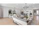 Open-concept living space with kitchen, dining, and living areas in a modern design at 6035 Blue View Way, St Cloud, FL 34771