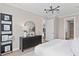 Light-filled main bedroom features a dark dresser and a view into another room at 6035 Blue View Way, St Cloud, FL 34771