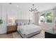 Light and airy main bedroom features paneling and a view to the outside at 6035 Blue View Way, St Cloud, FL 34771