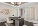 Clean office featuring neutral walls, dark wood floors, modern light fixture, and glass paneled french doors at 6035 Blue View Way, St Cloud, FL 34771