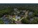 An aerial view showcases a well-manicured home in a neighborhood with tree-lined streets and beautiful landscaping at 605 Macglenross Dr, Oviedo, FL 32765