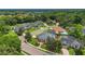 This aerial view showcases an elegant neighborhood with well-manicured lawns, mature trees, and a community pond at 605 Macglenross Dr, Oviedo, FL 32765