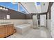 Bright bathroom features a soaking tub, glass shower, and skylight above at 605 Macglenross Dr, Oviedo, FL 32765