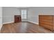 Empty bedroom with dark wood floors, shuttered windows and neutral walls at 605 Macglenross Dr, Oviedo, FL 32765