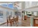 Bright dining area with pool view through large windows and glass doors, wood floors, and ceiling fan at 605 Macglenross Dr, Oviedo, FL 32765