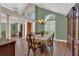 Elegant dining area featuring hardwood floors, high ceilings, decorative lighting, and classic decor at 605 Macglenross Dr, Oviedo, FL 32765