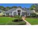 Charming single Gathering home featuring well-manicured lawn and attractive front yard landscaping at 605 Macglenross Dr, Oviedo, FL 32765