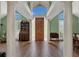 Bright foyer featuring soaring ceilings, grand columns, wood floors, and natural light at 605 Macglenross Dr, Oviedo, FL 32765
