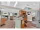 Open kitchen featuring a breakfast bar, wood cabinets, and seamlessly connected to a living area at 605 Macglenross Dr, Oviedo, FL 32765