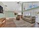 Open-concept living room with vaulted ceilings, hardwood floors, and abundant natural light at 605 Macglenross Dr, Oviedo, FL 32765