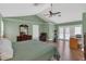 Large main bedroom with a ceiling fan, gym equipment and pool access via French doors at 605 Macglenross Dr, Oviedo, FL 32765