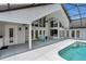 This screened lanai features a pool, dining area, and lots of windows, offering a great spot to relax and enjoy the view at 605 Macglenross Dr, Oviedo, FL 32765