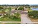 Beautiful aerial view of a landscaped home with a three-car garage, near a serene pond and green surroundings at 611 Curly Fern Ln, Deland, FL 32720