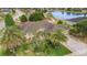 Aerial view of a well-maintained property with lush landscaping, a water feature, and a spacious layout at 611 Curly Fern Ln, Deland, FL 32720