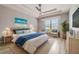 Bright bedroom with tray ceilings, ceiling fan, neutral colored walls, and light colored furnishings at 611 Curly Fern Ln, Deland, FL 32720