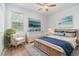 Bright bedroom with ceiling fan, artwork, neutral walls, and light colored furnishings at 611 Curly Fern Ln, Deland, FL 32720