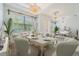 Elegant dining room featuring modern chandeliers, a large dining table, and lots of seating at 611 Curly Fern Ln, Deland, FL 32720