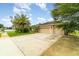 Driveway leading to charming single-story home with a two-car garage, showcasing ample parking space at 611 Curly Fern Ln, Deland, FL 32720