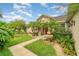 Charming single-story home featuring a red door, a fountain, and a well-manicured lawn at 611 Curly Fern Ln, Deland, FL 32720