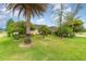 Charming single-story home featuring a lush, well-manicured lawn and numerous trees at 611 Curly Fern Ln, Deland, FL 32720