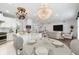 Kitchen and dining area featuring chandeliers and stainless steel appliances, and view to living room at 611 Curly Fern Ln, Deland, FL 32720