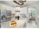 Bright kitchen with granite counters, stainless steel appliances, and view to dining area at 611 Curly Fern Ln, Deland, FL 32720