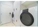Efficient laundry room with modern washer and dryer, and ample storage with white cabinets at 611 Curly Fern Ln, Deland, FL 32720
