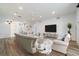 Spacious living room with white walls, wood floors, and stylish neutral furnishings at 611 Curly Fern Ln, Deland, FL 32720