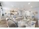 Bright, open living room with hardwood floors, plush sofas, and view to adjacent dining and kitchen areas at 611 Curly Fern Ln, Deland, FL 32720
