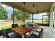 Inviting screened-in porch with dining and seating areas, offering a serene outdoor living space at 611 Curly Fern Ln, Deland, FL 32720