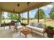 Cozy screened porch with comfortable seating, perfect for relaxing and enjoying the view at 611 Curly Fern Ln, Deland, FL 32720