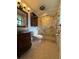 Bathroom with stylish vanity, vessel sink, glass-enclosed shower, and updated fixtures offers a modern feel at 6615 Beamer Way, Orlando, FL 32807