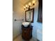 Charming powder room featuring decorative vessel sink and elegant lighting fixture at 6615 Beamer Way, Orlando, FL 32807