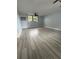 Bedroom with wood-look tile floors, natural light, a ceiling fan, and neutral paint creating a comfortable space at 6615 Beamer Way, Orlando, FL 32807