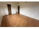 A well-lit bedroom with hardwood floors and a spacious closet, offering ample storage at 6615 Beamer Way, Orlando, FL 32807