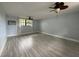 Bedroom features a ceiling fan, wood-look tile floor, natural light, and neutral paint for a serene atmosphere at 6615 Beamer Way, Orlando, FL 32807