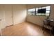 A simple bedroom is displayed, with light-colored walls, a dark trim window, and a hardwood floor at 6615 Beamer Way, Orlando, FL 32807