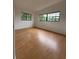 Bright bedroom featuring hardwood flooring and sunlit windows, creating a warm and inviting space at 6615 Beamer Way, Orlando, FL 32807