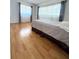 Comfortable bedroom featuring hardwood floors, natural light, and neutral décor at 6615 Beamer Way, Orlando, FL 32807