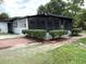 Charming home exterior with a screened in porch and well-maintained landscaping at 6615 Beamer Way, Orlando, FL 32807