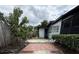Exterior view of house with paved path and greenery at 6615 Beamer Way, Orlando, FL 32807