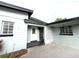 Home exterior showcases a concrete driveway and walkways leading to a welcoming front entrance with detailed features at 6615 Beamer Way, Orlando, FL 32807