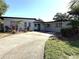 Attractive single-story home boasting a spacious driveway and charming curb appeal with a landscaped front yard at 6615 Beamer Way, Orlando, FL 32807