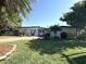 Charming single-story home featuring a well-manicured front yard with lush landscaping and mature trees at 6615 Beamer Way, Orlando, FL 32807