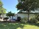 Inviting single-story home with a well-kept lawn, landscaping, and a spacious driveway leading to the entrance at 6615 Beamer Way, Orlando, FL 32807