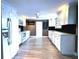Renovated kitchen featuring white cabinets, stainless appliances, and sleek countertops at 6615 Beamer Way, Orlando, FL 32807