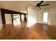 Open-concept living room with hardwood floors and access to other living spaces at 6615 Beamer Way, Orlando, FL 32807